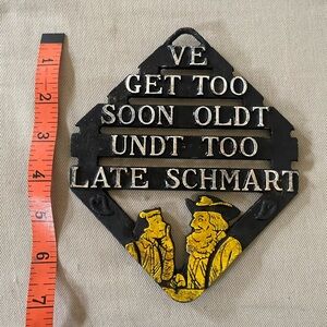 Vintage cast iron Ve Get Too Soon Oldt trivet